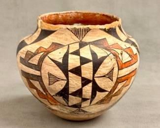 Antique Native American pottery: An Acoma Pueblo olla—a water jar or storage vessel—formed from hand-coiled clay decorated with a white slip background, accented by vibrant polychrome geometric panels and stylized bird or feather elements. Approximately 8-1/4” tall. Repairs as shown.