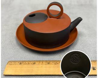 Another view of the CCCI (Chinese Ceramic Center Inc.) red and black clay teapot with dish, mark to base.