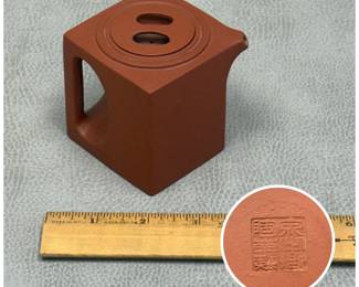 Another view of the modern geometric Yixing zisha clay teapot in a striking minimalist cube shape with a flush lid and an integrated loop handle, chop mark to base.