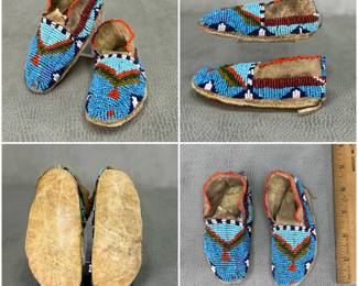 Vintage pair of Native American children's beaded moccasins, likely Lakota Sioux; tanned hide sinew-sewn with glass seed beads in light and medium blue, dark blue, white, red, amber, and green. Approximately 4 inches long. 