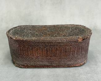 Antique hand woven twill plaited Southeast Asian lidded basket, 10"L x 4"H.; collector's label reads "very old tobacco basket Thailand"