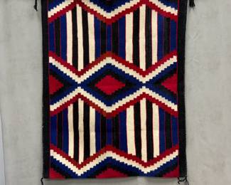 A Navajo third phase chief's blanket with stepped diamond pattern in red, black, blue and white; 30" x 39" 