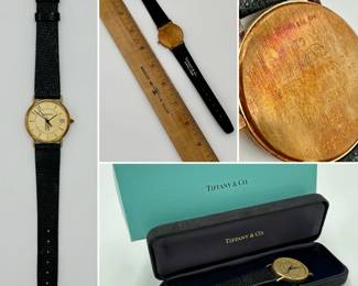More views of the vintage Tiffany & Co. 14k yellow gold dress wristwatch featuring a round gold-tone case, a textured champagne dial with baton markers, a date window at the 3 o'clock position, and a graphic illustration of the Chicago Tribune Tower, on a black leather strap. In original presentation box, the back of the watch is stamped 14K Tiffany & Co., and inscribed with "To A. Arnam in recognition of the completion of 30 years service 1994 Chicago Tribune.”