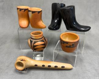 Southwestern Native American pottery miniatures including a pair of Santa Clara blackware boots, a pair of Pueblo pottery redware moccasin boots, and redware olla, jar, and pipe