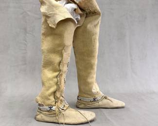 Antique Native American high-top or legging-style moccasins, crafted from tanned hide with intricate beadwork, side fringe and hard soles. Commonly associated with Southern Plains traditions from the late 19th to early 20th century.
