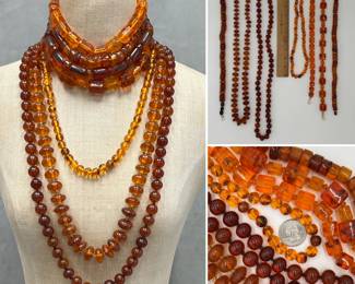 A collection of natural amber bead necklaces - one with a 14k white gold clasp - featuring warm honey and deep cognac tones in various round, faceted, and chunky block shapes
