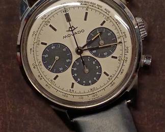 A vintage 1950s-60s Movado M95 "SUB-SEA" Chronograph wrist watch with black leather strap, in the original box. This watch has Movado Factories Swiss in-house Calibre M95 - a 17-jewel, manual-wind, column-wheel chronograph movement developed in partnership with Frédéric Piguet. Case is stainless steel, Fabrique de Boîtiers (FB) / François Borgel. Screw-down caseback stamped with Movado crown, case no. 2496, ref. 95.704.568 with "SUB-SEA" engraved on the case band.