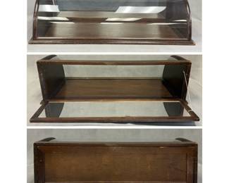 More views of the antique curved glass countertop display case, commonly used in turn-of-the-century general stores, bakeries, and jewelry shops; dark wooden frame and base and single, continuous piece of bent or curved glass that forms the top and front viewing window. 31.5"W x 9.5"H x 16"D