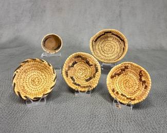 A selection of Native American hand-woven miniature baskets ranging from 1" to 3" wide