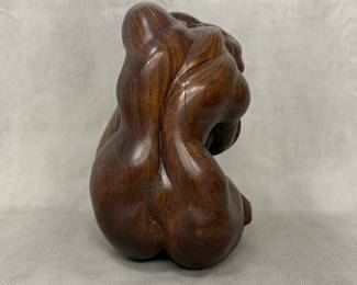 Closer view of the hand-carved wooden sculpture of seated female figure, 11 inches tall, with polished dark wood finish with prominent natural grain patterns