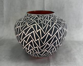 A hand-coiled and hand-painted Acoma Pueblo black-on-white pottery vessel featuring a traditional geometric zig-zag lightning and rain pattern, signed E. P. Routzen (Elsie P. Routzen, 1934–2002)