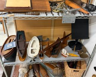 A collection of handcrafted decorative wooden model boats and hulls; a miniature brass ships nautical anchor; a collection of vintage wooden Indian exercise clubs and juggling pins