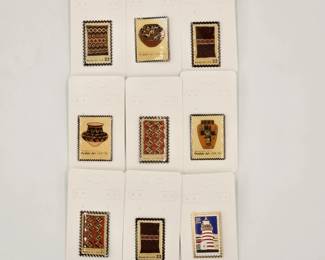 A set of 1980s vintage cloisonné enamel collector's pins featuring designs from U.S. Postal Service's American Folk Art series including several Navajo Art stamps, Pueblo Art stamps, and one lighthouse from Maine stamp.
