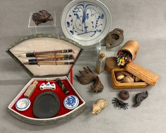 A vintage traditional Chinese calligraphy and painting set housed in a fan-shaped, fabric-covered presentation box; hand-carved wooden toad and goldfish; a woven box containing various pottery "tea pets" (shapes include walnut, chestnut, gourd, peanut, bat), an antique Chinese blue and white export porcelain dish; an ancient-style terracotta or clay oil lamp