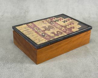 A vintage Peruvian hand-made wooden trinket box featuring a framed pre-Columbian Andean textile fragment ( Paracas or Inca style) under glass with a metal border