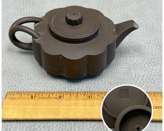 A Chinese Yixing zisha clay gongfu teapot featuring a lobed Ling Hua (petaled/chrysanthemum) floral compressed body and a matching textured finial; artisan mark to the interior of the cover and to the base
