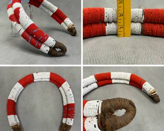 A vintage, handcrafted African beaded roll or coil accessory, likely originating from South African or East African traditions such as the Zulu or Kamba peoples, featuring intricate red, white, and light blue glass seed beads on a fiber or cloth core