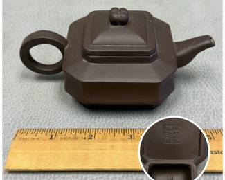 A small traditional Chinese Yixing unglazed dark brown clay gongfu teapot, makers mark to base and inside of lid