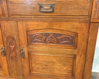 antique oak sideboard, possibly dating from the 1910s, featuring Art Nouveau style carvings