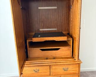 Thomasville Fisher Park armoire, featuring solid pecan wood construction and ornate brass hardware