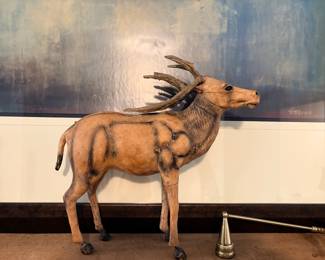 vintage, hand-crafted deer or stag figure featuring a paper-mâché or similar body structure wrapped in genuine leather