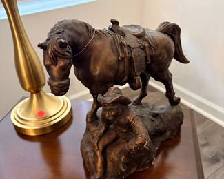 Austin Productions artist-signed western cowboy and horse sculpture is crafted from cast metal or chalkware