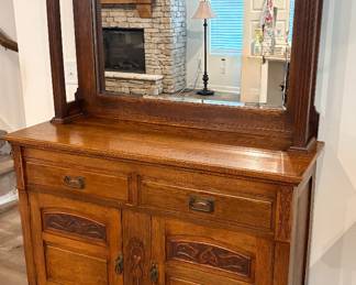 antique oak sideboard, possibly dating from the 1910s, featuring Art Nouveau style carvings