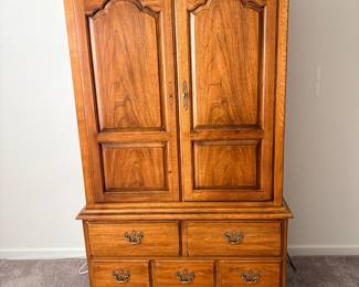 Thomasville Fisher Park armoire, featuring solid pecan wood construction and ornate brass hardware
