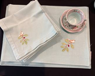 Adams Calyx Ware dinnerware in the Singapore Bird pattern, featuring a distinctive octagonal shape and colorful bird-and-floral motif. Placemats and napkins to match