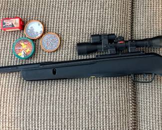 Gamo Varmint .177 Caliber Break Barrel Air Rifle, featuring a matte black synthetic stock and a mounted Gamo scope.The rifle operates using a spring-piston mechanism designed for pest control and target practice