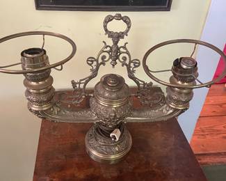 **Pair of antique electrified brass oil lamps, late 19th century\.** One reservoir is stamped *The Brilliant* with an 1898 patent date\. Beautiful aged brass with rich original patina\. One lamp retains its original glass; the other is missing its shade\. From a long\-held family collection\.