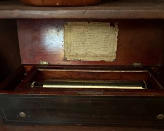 swiss music box- plays 12 songs works perfectly. Current bud $1000