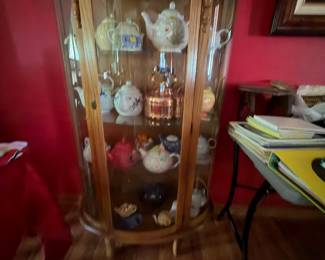 Curio cabinet , tea pots 