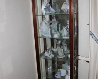 Curio cabinet filled with Lladro and other figurines