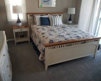 Queen bedroom suite: queen bed; nightstands; table lamps; dresser with mirror
