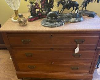 Detail of walnut marble top chest