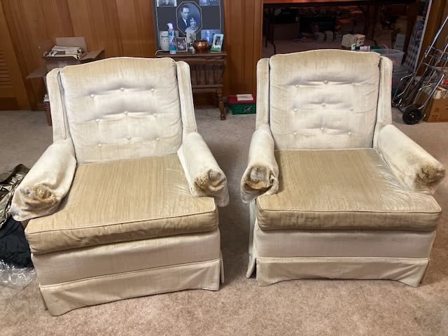 A matching pair of vintage Clyde Pearson high-back club armchairs featuring tufted backrests, rolled padded arms, and pleated skirt bases upholstered in light cream/gold crushed velvet.