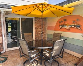 This 5-piece patio set includes four swivel chairs and a table with a central umbrella hole.