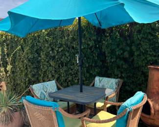 5-piece outdoor wicker chair and metal dining set with umbrella and cushions. This set has a space saving design and weather resistant materials.