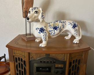 Reproduction radio with porcelain dachshund and carved bird