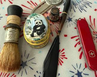 vintage shaving brush, panda trinket box, swiss army knife, letter opener