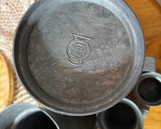 Makers mark on bottom of Dutch pewter measuring cups. 