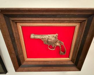 Old framed rusty gun.