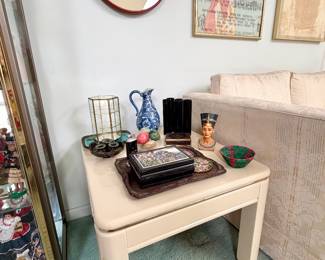 One of two cream end tables.