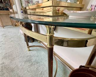 Brass and glass half moon console table.