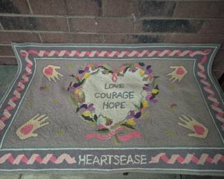 Area rugs. "Heartsease Love Courage Hope" hook rug by Claire Murray