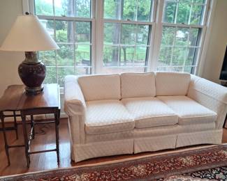 White diamond upholstered sofa.