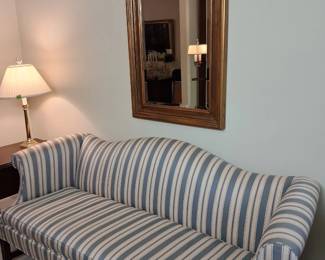 upholstered sofa and wonderful gilt mirror.