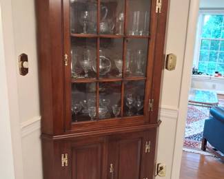 There are 2 of these amazing Henkel Harris Corner Curios with lighted interiors snd brass fixtures. The other is pictured below with lights on. Henkel Harris