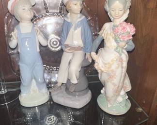 Lladro Collection: Sailor Boy with Yacht (#4810), Puppy Love (#1127), and Girl Holding Flowers